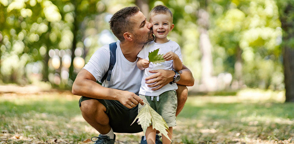 Summer time for family fun in the wood. Father and son dressed i