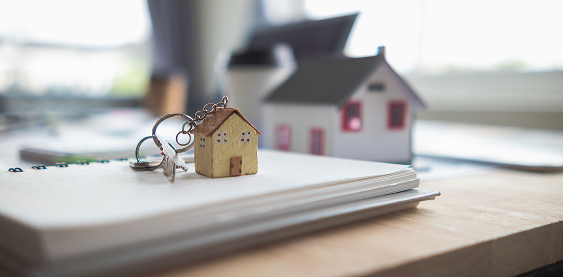 Real estate sales documents and model homes are placed on tables