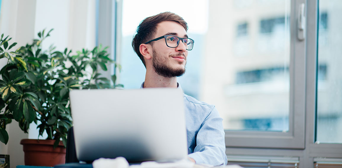 Young businessman in office working on laptop