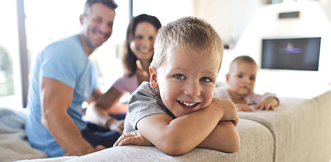 Smiling kids with their parents in the living room