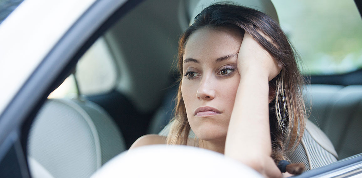 Bored woman waiting patiently in her car