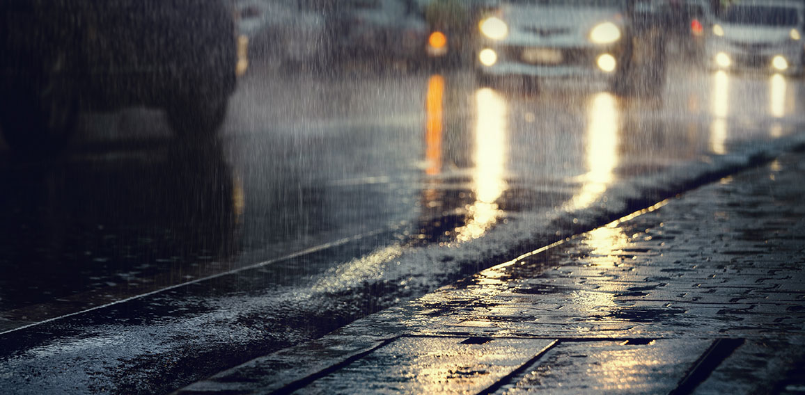 Hard rain fall in the city with blurry cars .Selective focus.