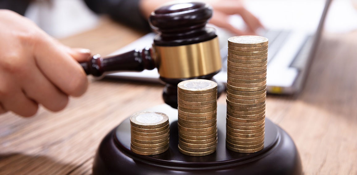 Stack Of Increasing Coins On Gavel At Workplace