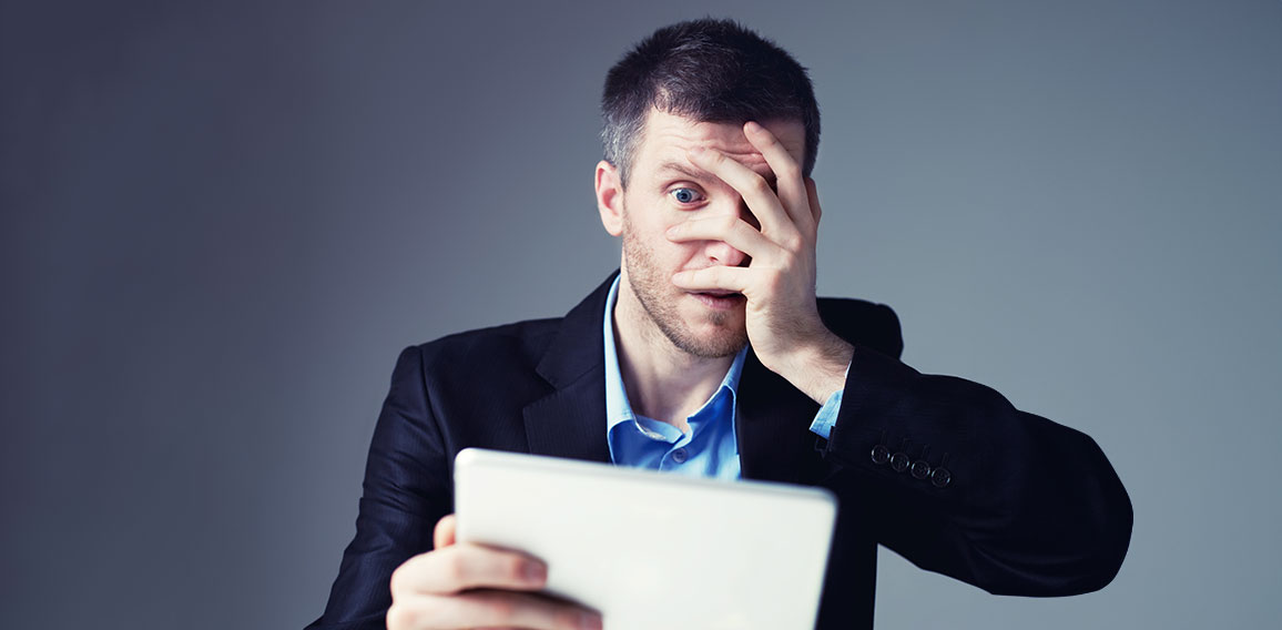 Shocked businessman with digital tablet