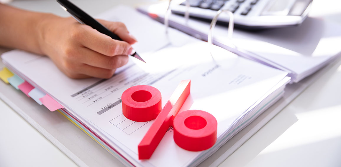 Businessperson's Hand Calculating Bill With Calculator