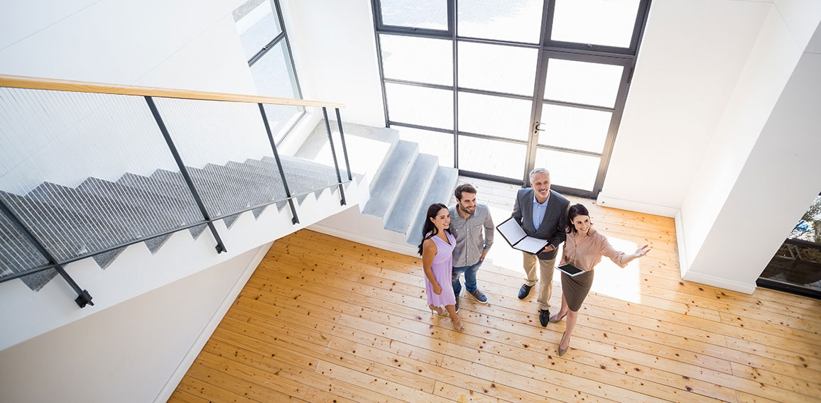 Real estate agent showing new house to couple