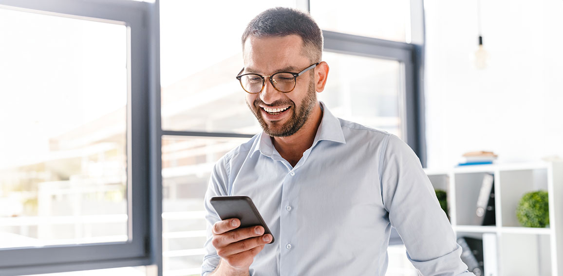 Image closeup of smiling employer guy in white shirt standing in