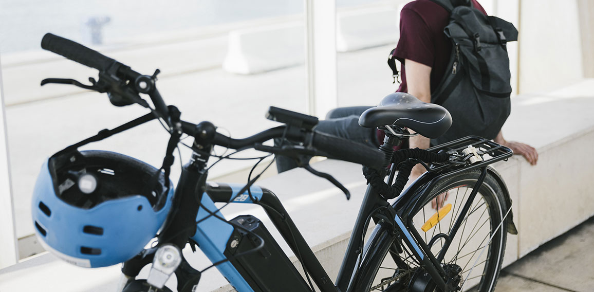 Close up electric bicycle with sitting man in background