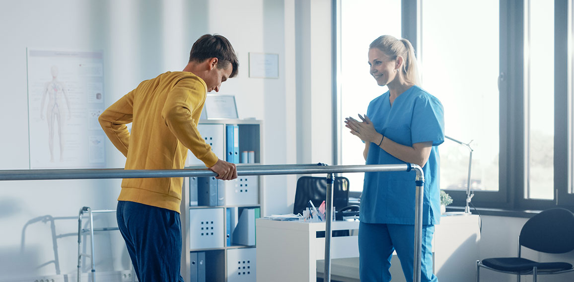 Hospital Physical Therapy Room: Strong Patient with Injury Walki