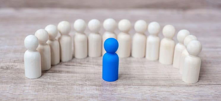 blue leader businessman with crowd of wooden men. leadership, bu