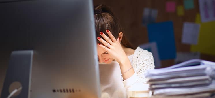 Young and beautiful businesswoman tired from work in the office