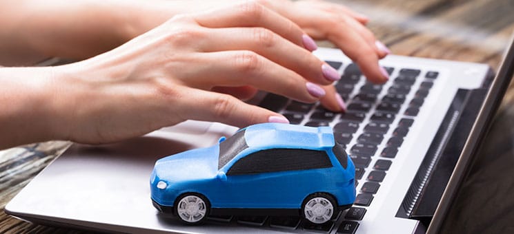 Small Blue Car On Laptop Keypad