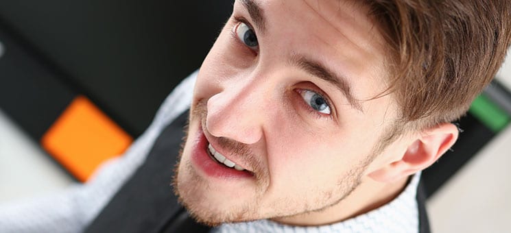 Young smile man at office workspace closeup