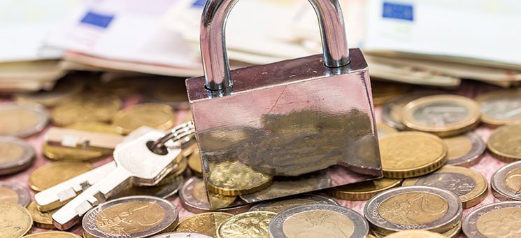 euro coin and banknote with lock. close up