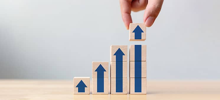 Ladder career path for business growth success process concept.Hand arranging wood block stacking as step stair with arrow up