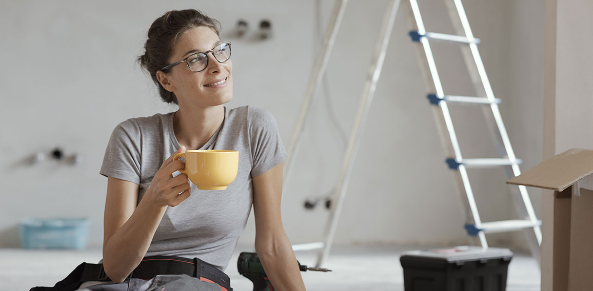 Woman doing a home renovation and having a coffee break