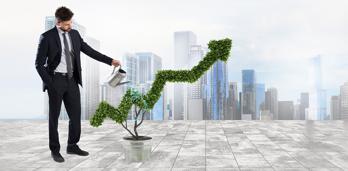 Businessman that watering a plant with a shape of arrow. Concept of growing of company economy .