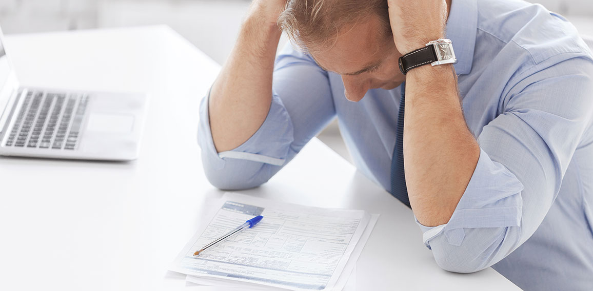 stressed businessman with papers at work