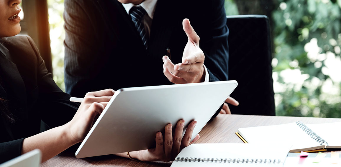 Business woman and lawyers discussing and using digital tablet