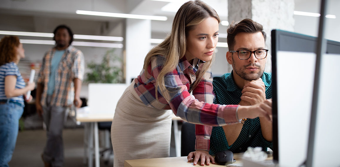 Group of business people and software developers working as a team in office