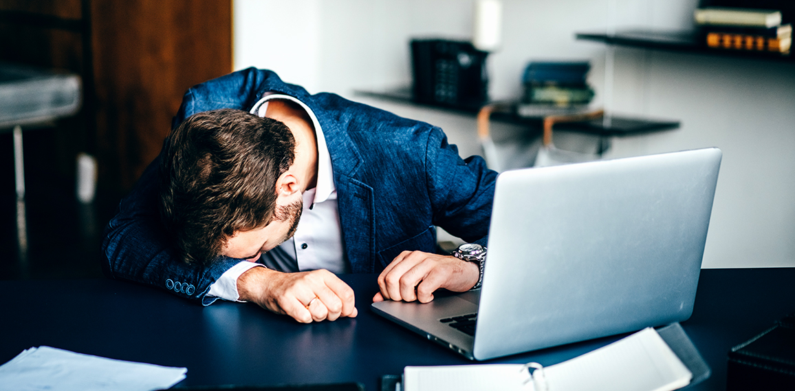 Sad businessman sitting at his desk.