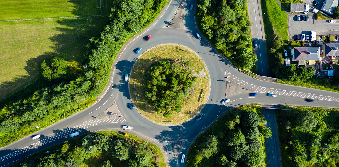 Aerial long exposure of traffic on a roundabout in a small town