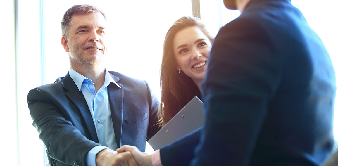 Business people shaking hands, finishing up a meeting.