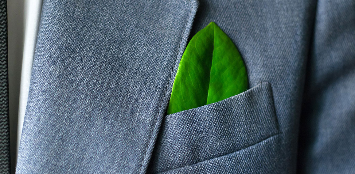 The businessman's photo in a suit with a leaf in a pocket