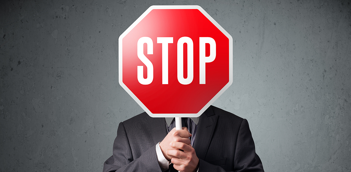 Businessman holding a stop sign