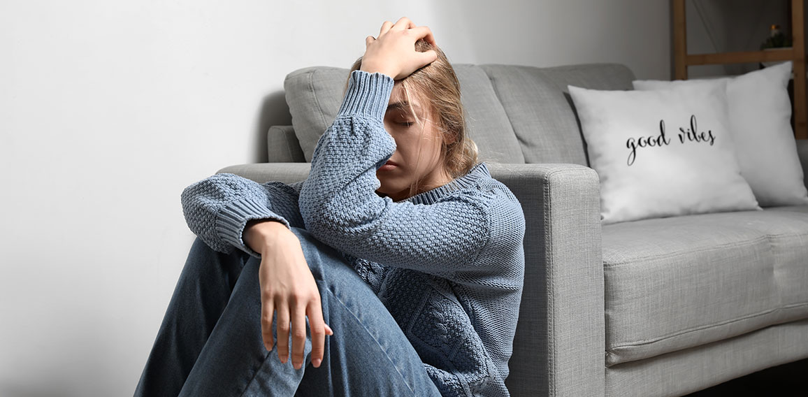 Depressed young woman at home