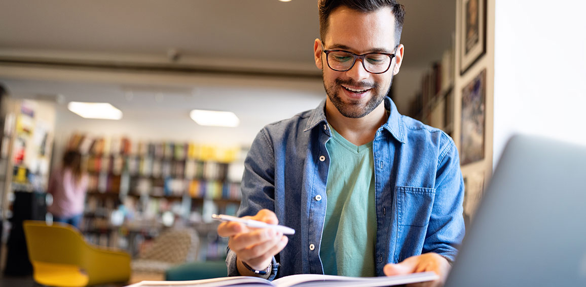 Student preparing exam and learning lessons in school library