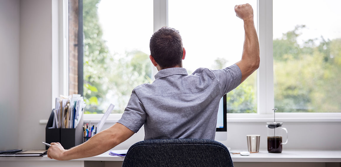 Rear View Of Man Working From Home On Computer  In Home Office S