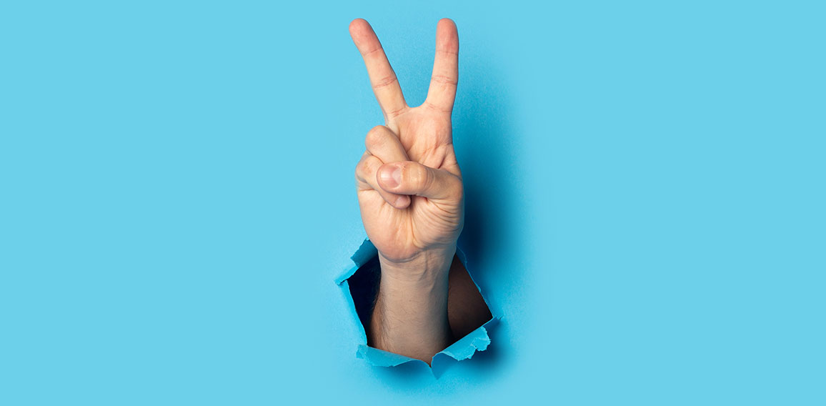 Male hand makes a two fingers up greeting gesture on a blue background. Banner