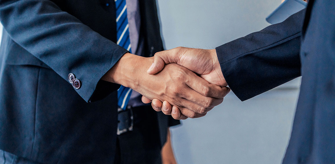 Business people handshake agreement in office.