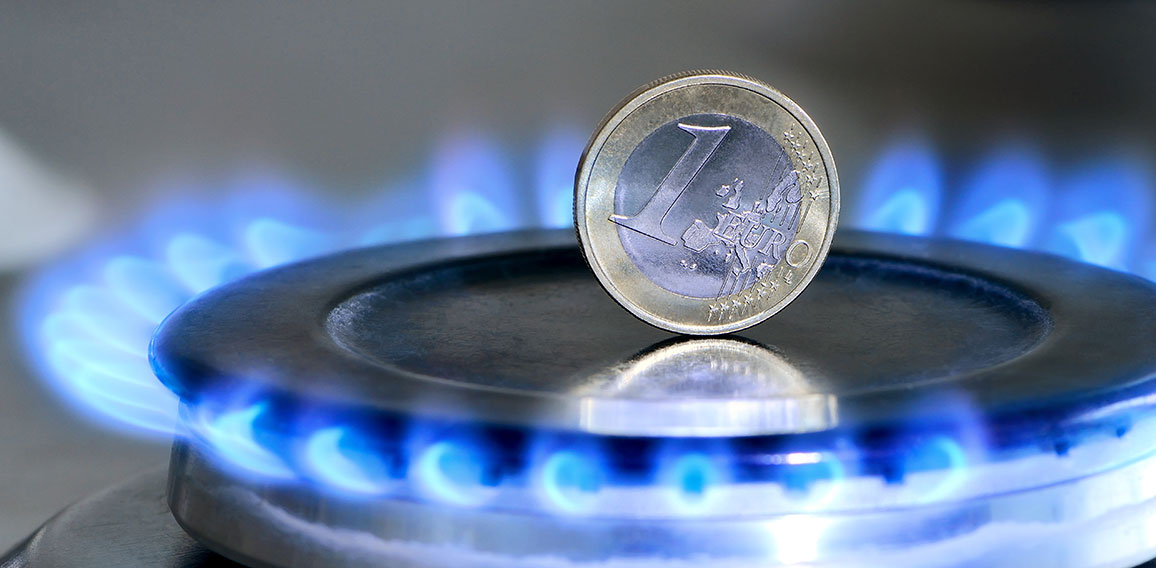 Burning natural gas and one euro coin on gas hob