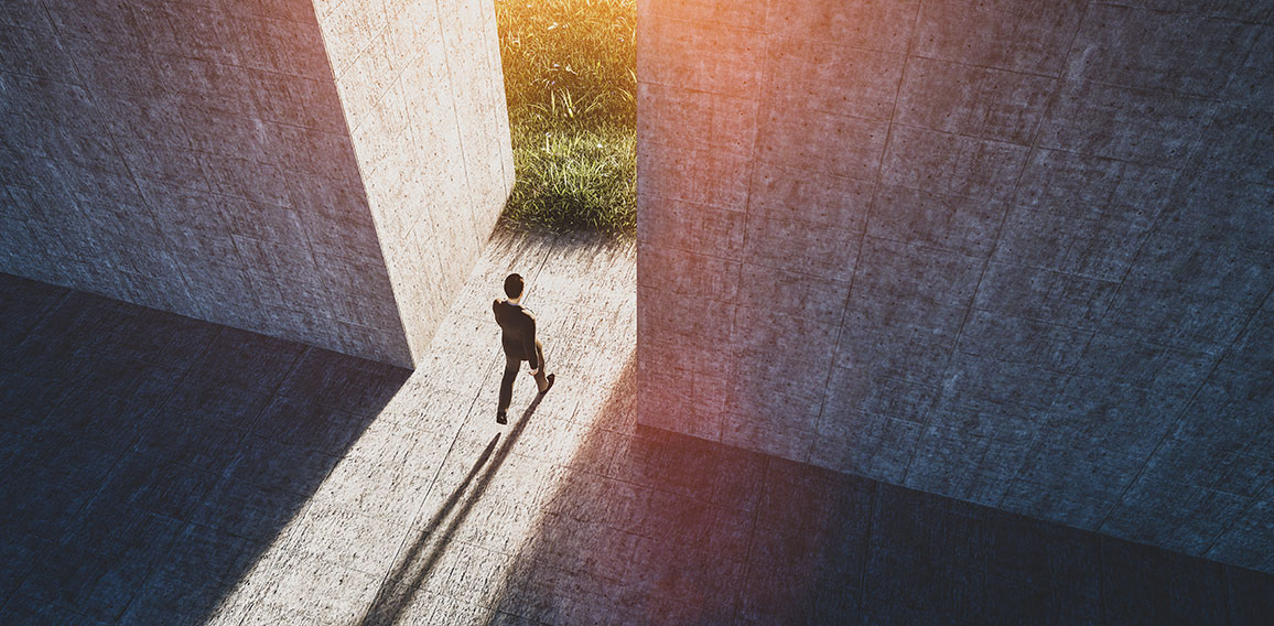 Businessman walking to open gate to a new better green world