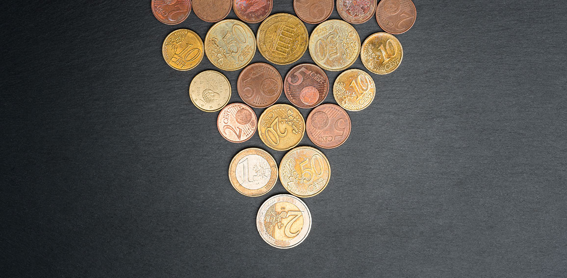 Christmas tree made out of Euro coins on slate plate.