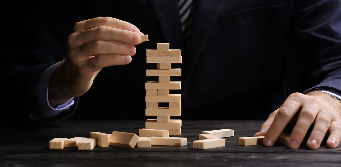 Young man with jenga at table