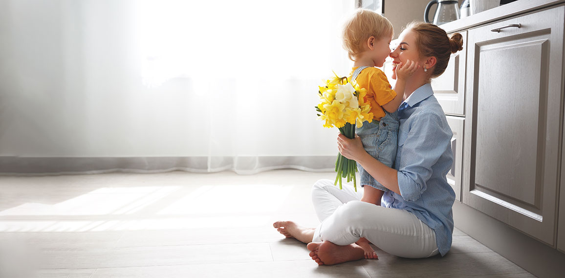 happy mother's day! baby son gives flowersfor  mother on holiday