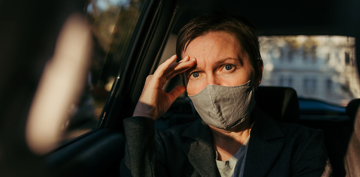 Anxious businesswoman sitting inside of the car and looking at c