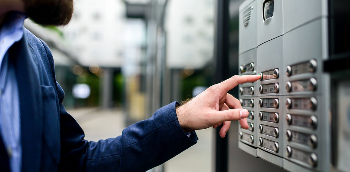 Man pushing the button and talking on the intercom