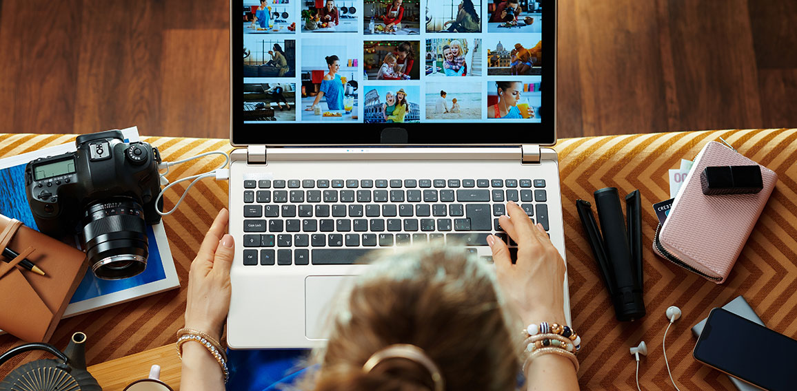 woman looks at image while transferring photos from DSLR camera