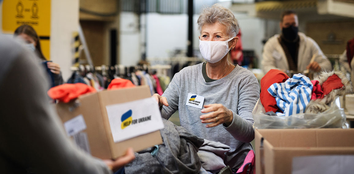 Volunteers collecting donations for the needs of Ukrainian migrants, humanitarian aid concept.