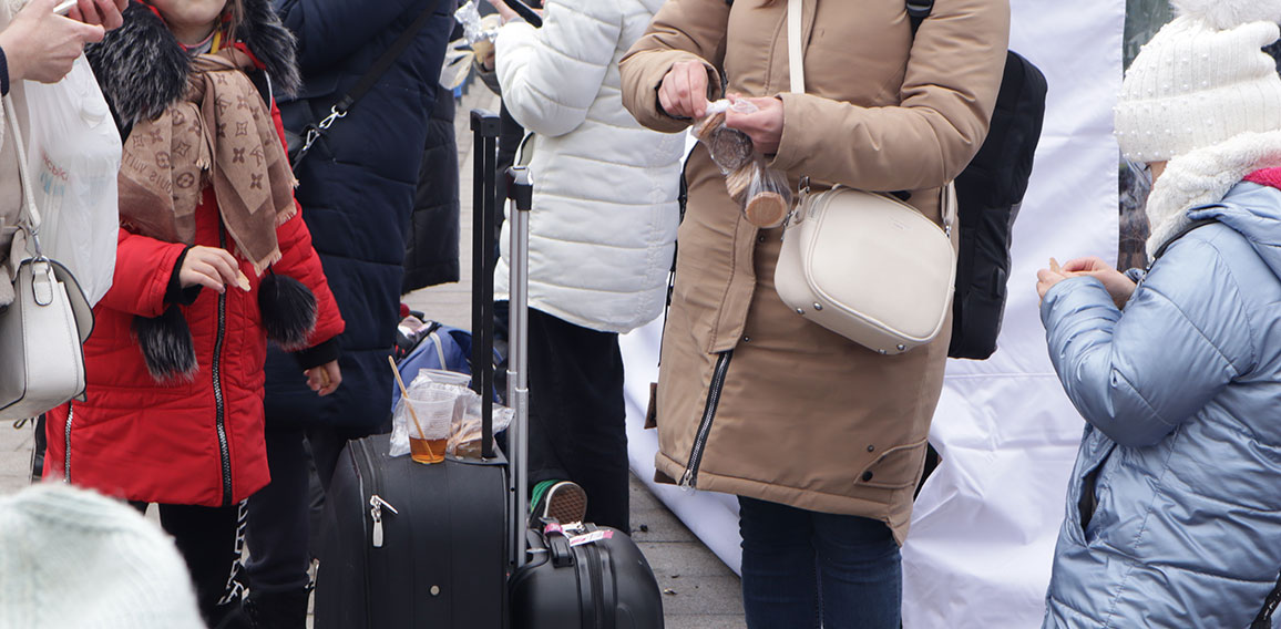 Russia's war with Ukraine. Refugees with suitcases in Lviv at the station, hungry, eat standing up