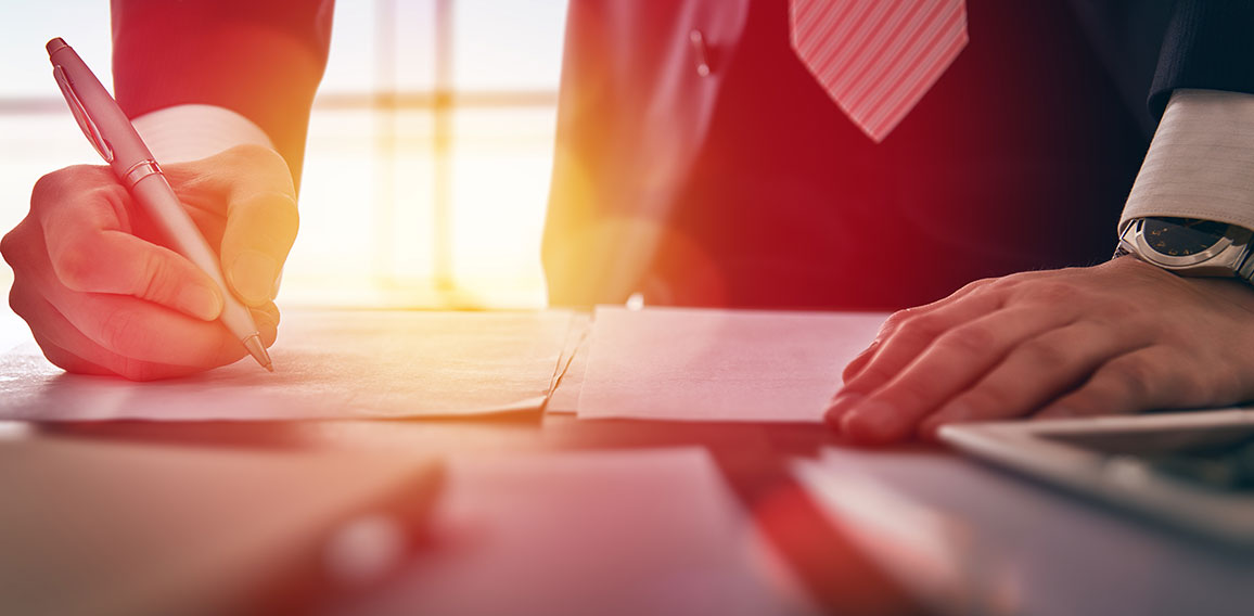 businessman signing documents