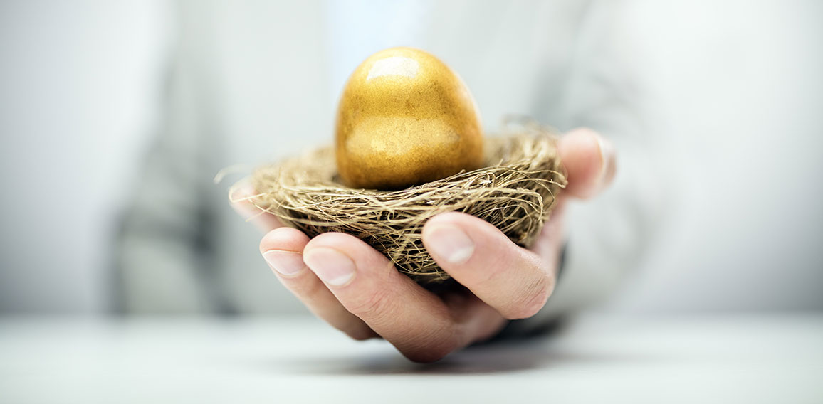 Retirement savings golden nest egg in businessman hand