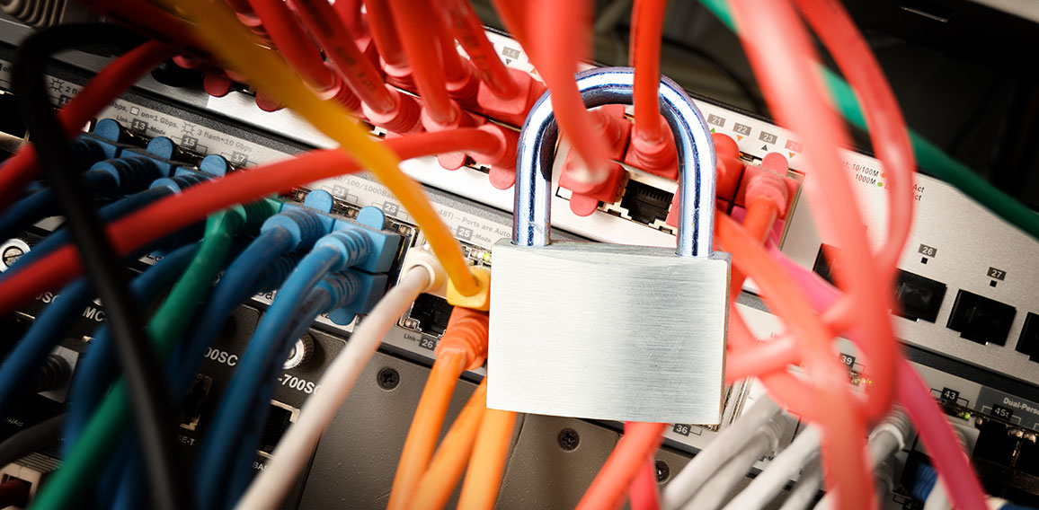 padlock on the colorful cables at a network server, safety conce