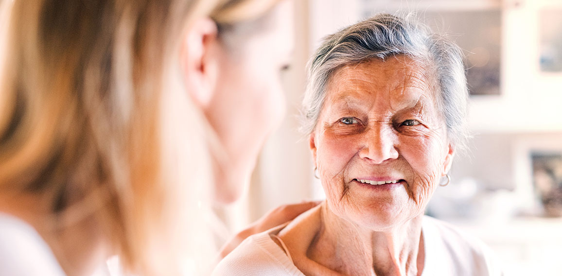 An elderly grandmother with an adult granddaughter at home.