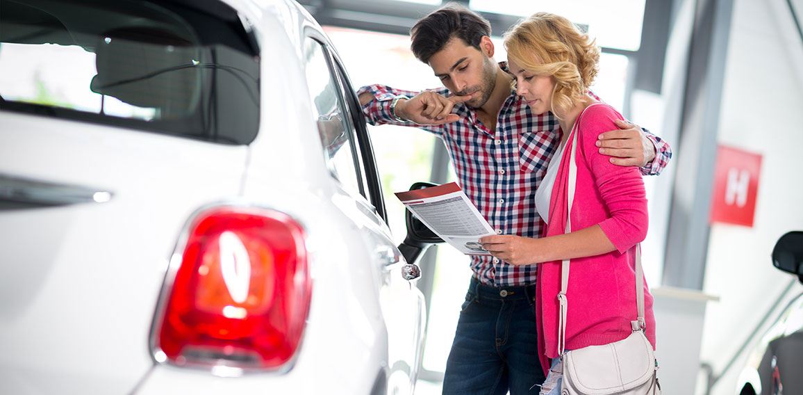 Happy couple chooses to buy a car