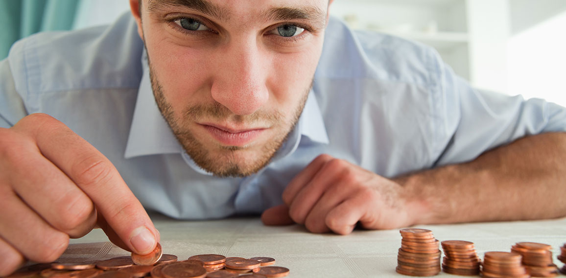 Desperate businessman counting his change